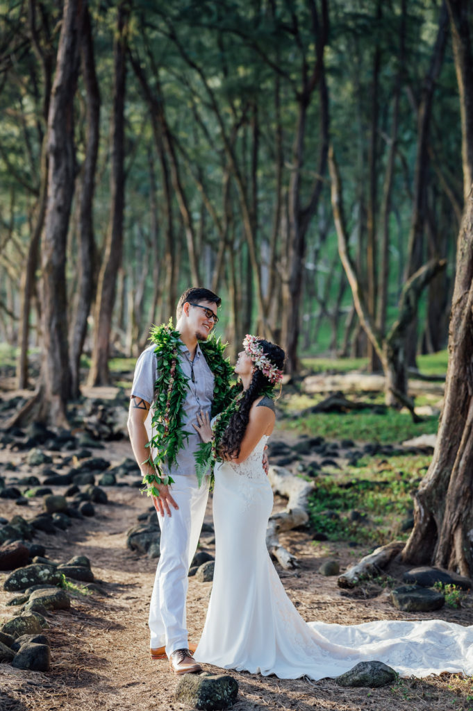 happy couple under the trees during their Hawaii elopement