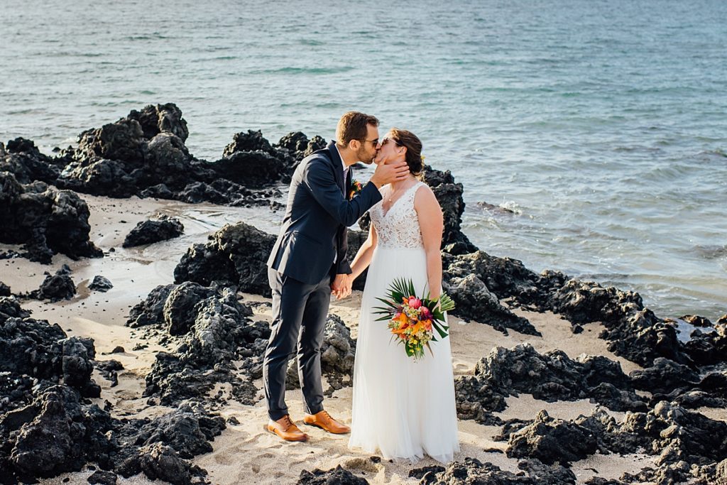 bride and groom kissing at Big Island beach