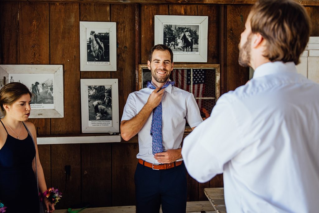 groom wearing his tie at Anna Ranch