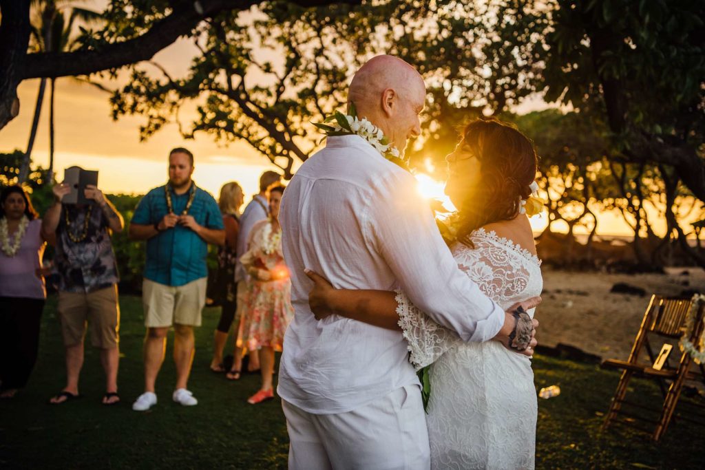 wedding photo of bride and groom dancing in the sunset