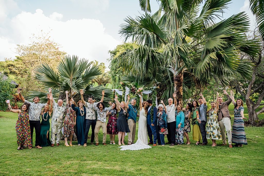 wedding photo of the bride and groom with their families in a Big Island wedding