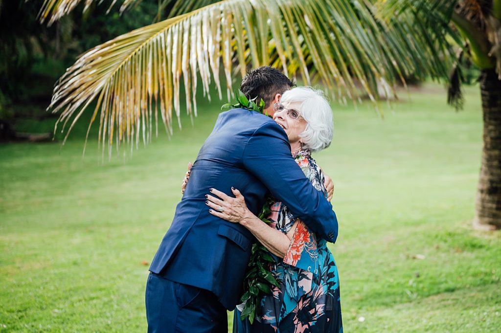 wedding photo of the groom and his grandma hugging each other during his Big Island wedding