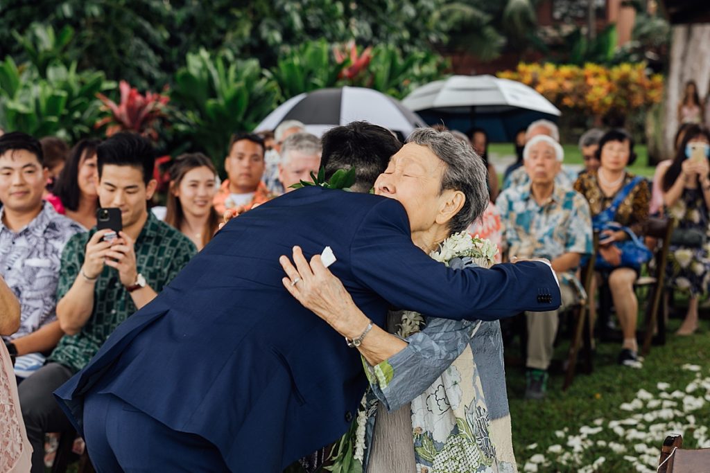 photo of the groom hugging his grandma during a wedding ceremony at Big Island