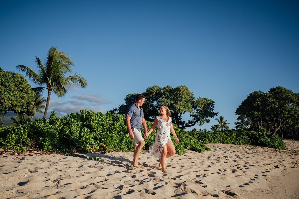 couple holding hands at the Hawaii beach 