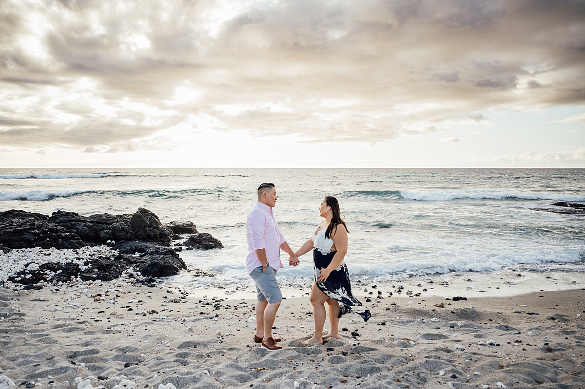 couple holding hands at the Big Island beach