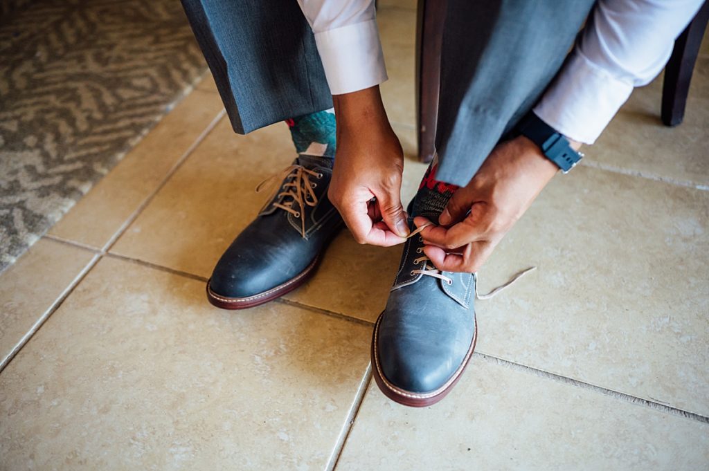 groom tying his shoes during his Big Island, Hawaii wedding