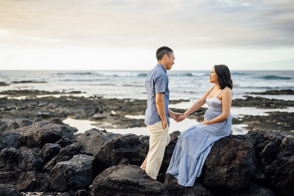 precious moments of the couple on the lava rocks at a beach in Kona, Hawaii