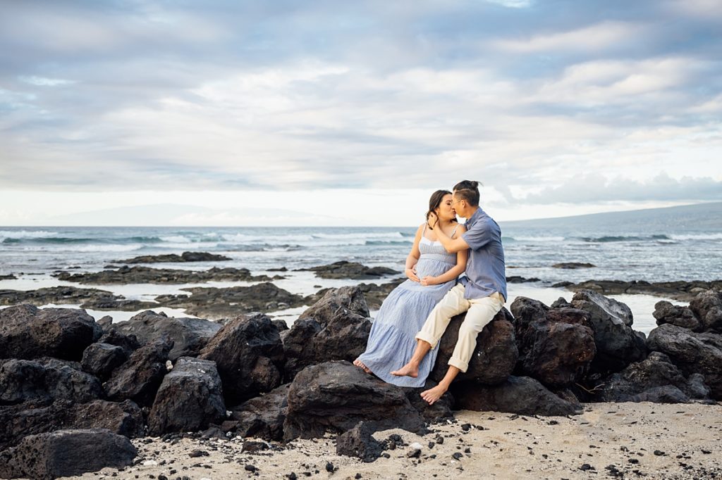 couple kissing on the lava rocks at a beach in Kona, Hawaii