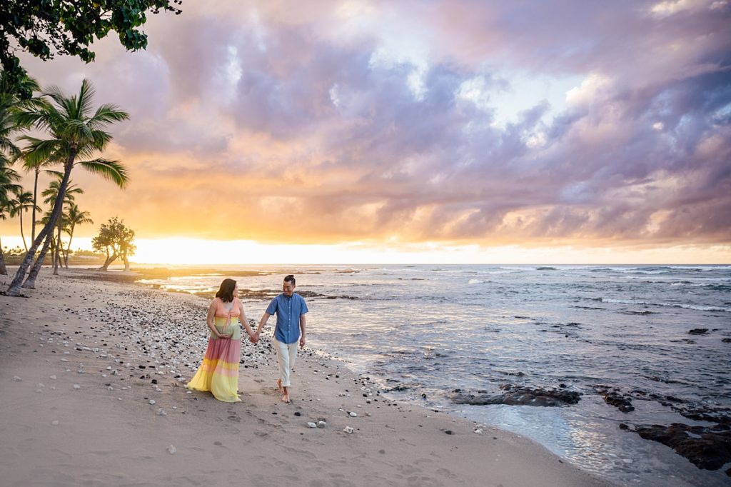 couple holding hands at the Hawaii beach by photographer