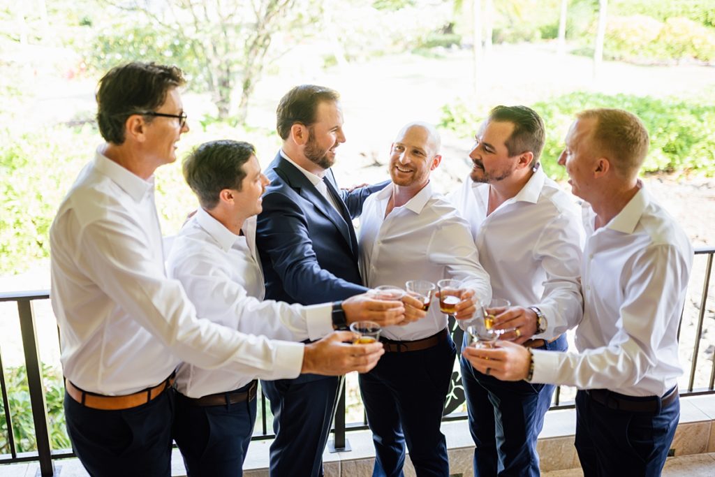 groom with his groomsmen having a toast during his wedding