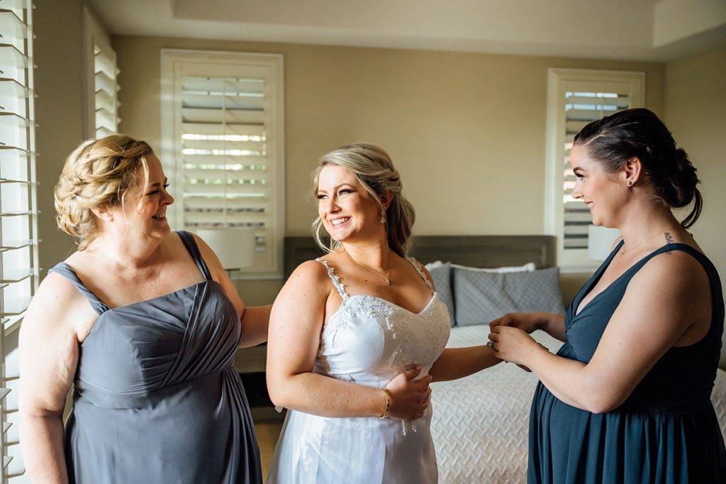 bride getting ready with mom and sister during her Big Island wedding