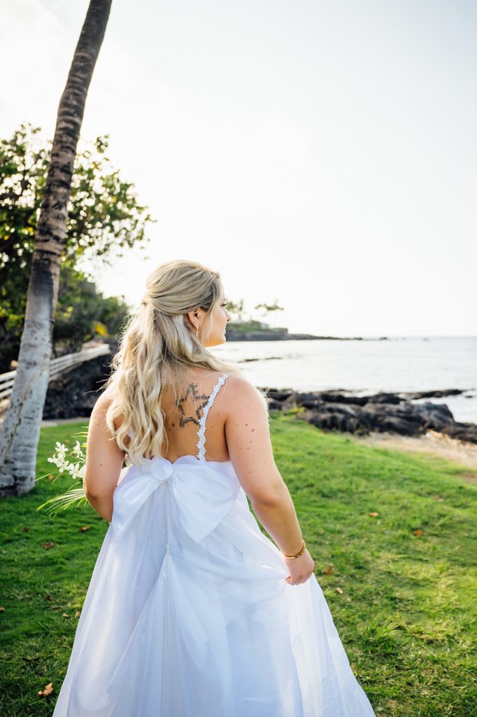 bride with a star tattoo on her back looking at the Mauna Lani beach