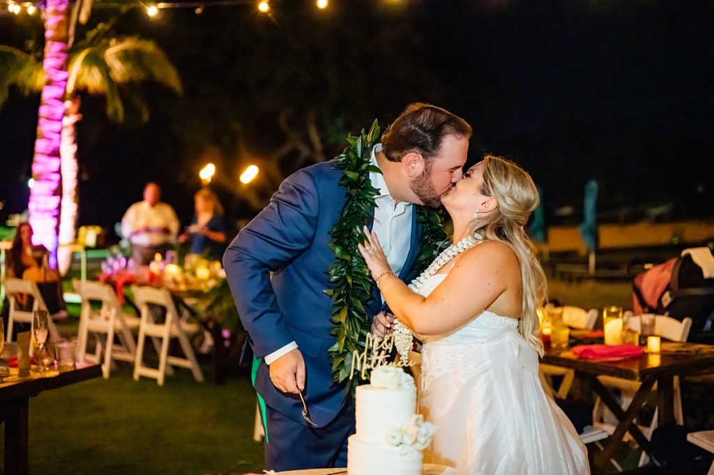 bride and groom kiss during their Mauna Lani wedding reception