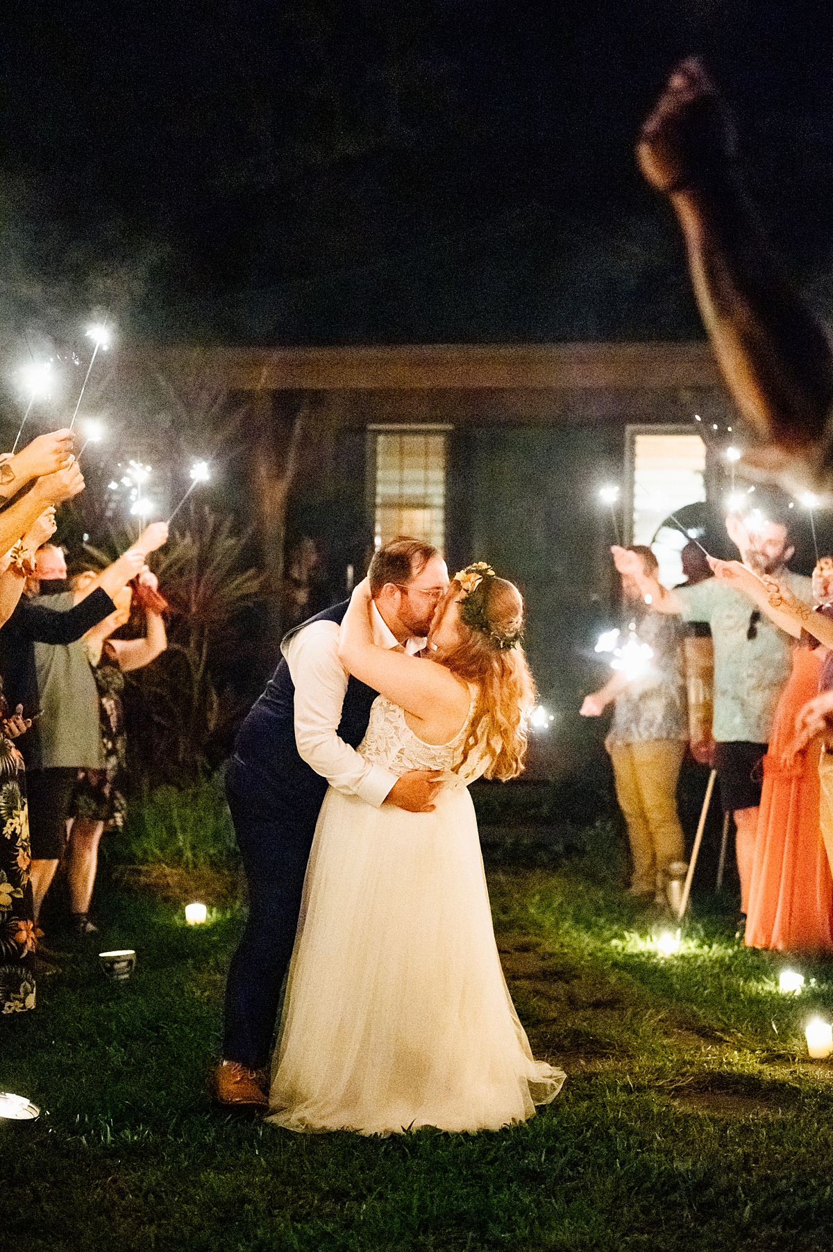 bride and groom kissing during their wedding reception in Hawaii