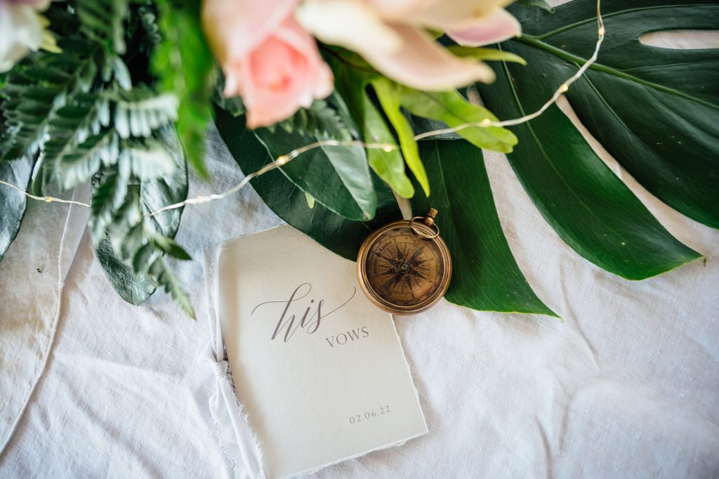 groom's vow booklet and compass by Hawaii wedding photographer