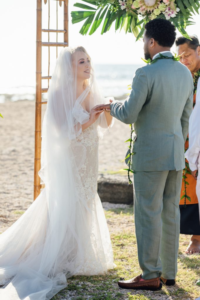bride and groom exchange of rings by Hawaii wedding photographer