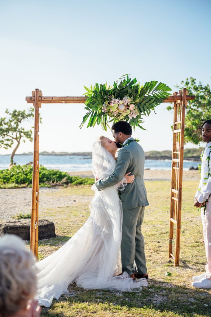 bride and groom kiss during their Hawaii wedding ceremony