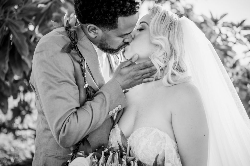 bride and groom kiss during their Hawaii wedding