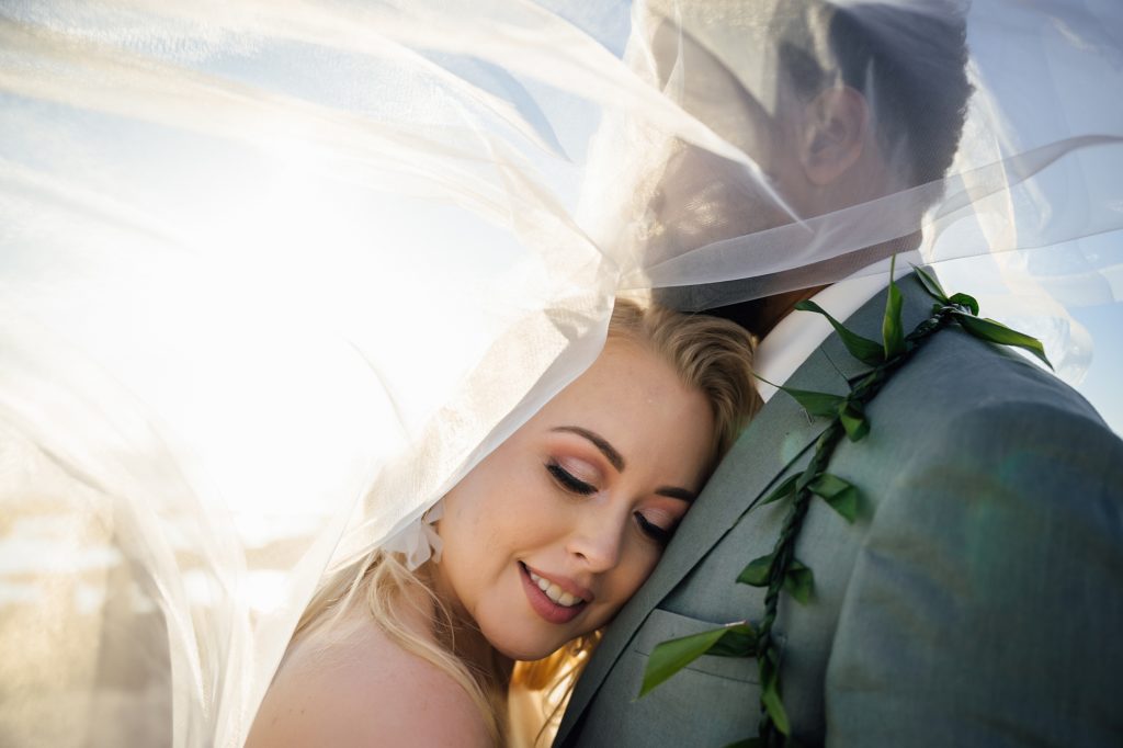 newlyweds under the veil by wedding photographer in Hawaii