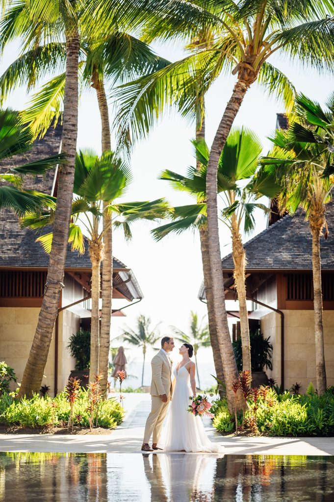 couple under the coconut trees by wedding photographer