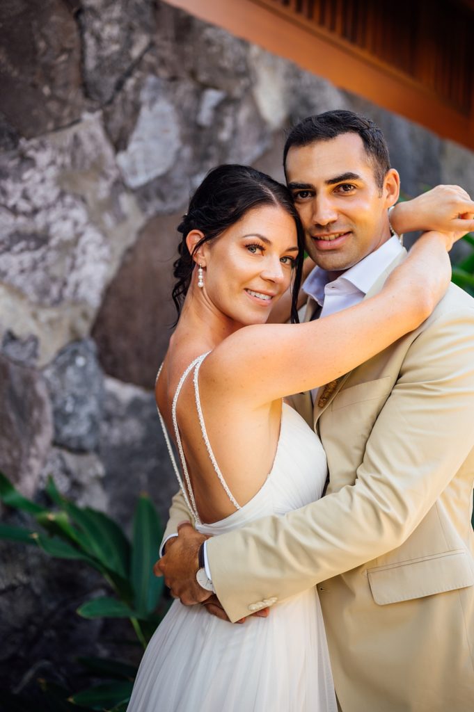 bride and groom embracing by Big Island wedding photographer