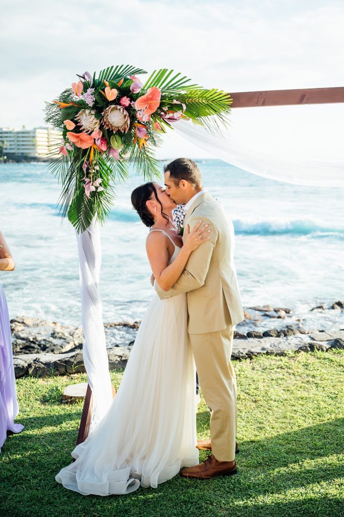 bride and groom kiss during their Big Island wedding ceremony