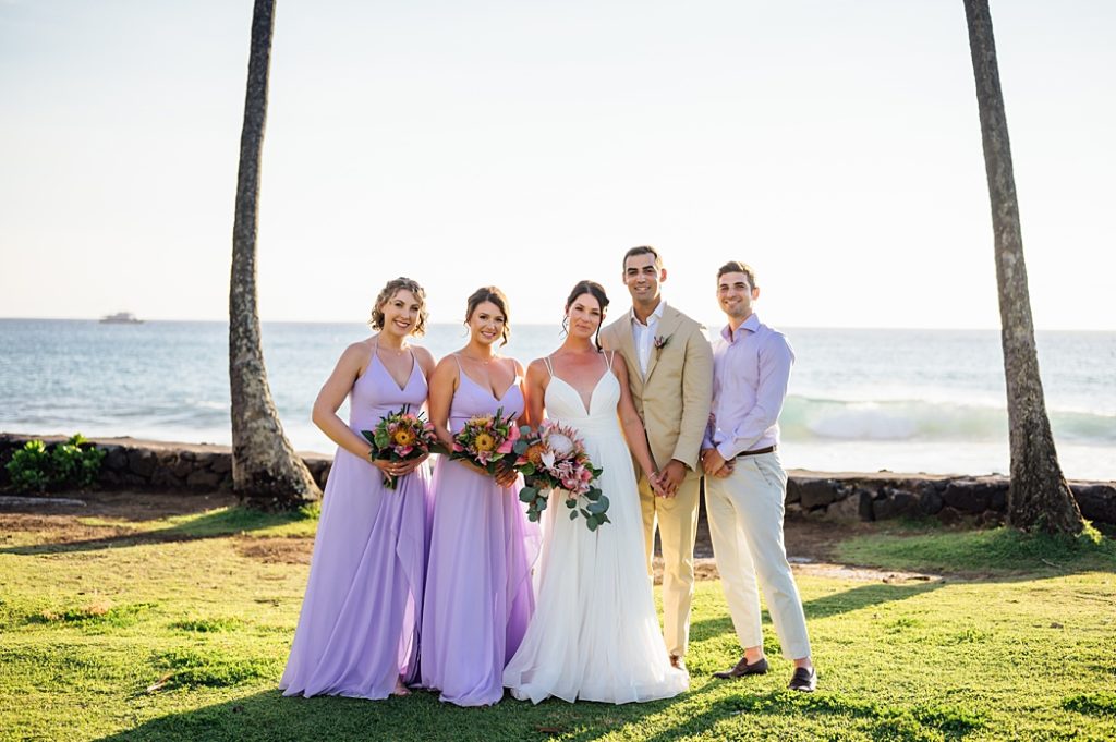 newlyweds with their wedding party at Big Island beach