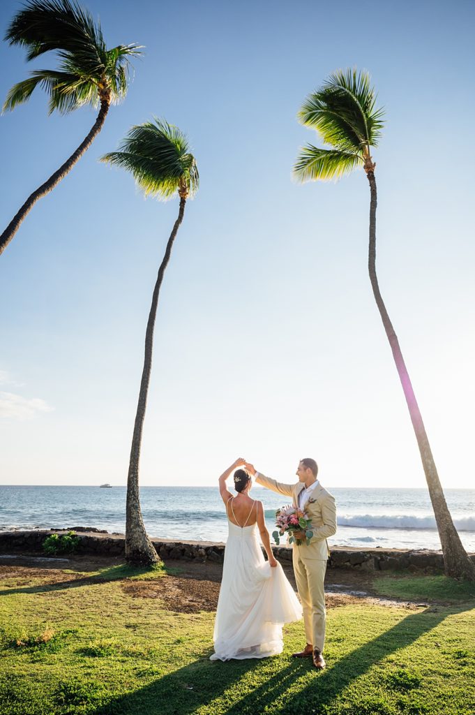 bride twirling on the beach by Big Island wedding photographer