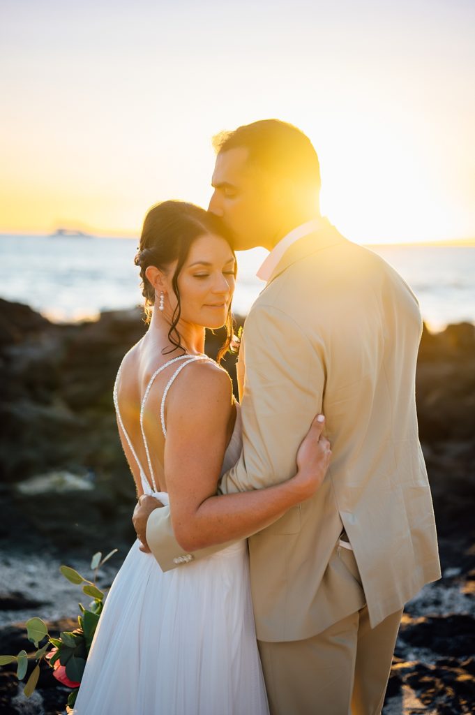 newlyweds under the Big Island stunning sunset by wedding photographer