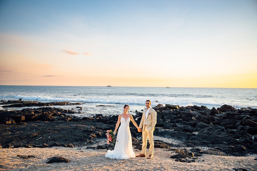 bride and groom holding hands at Big Island beach