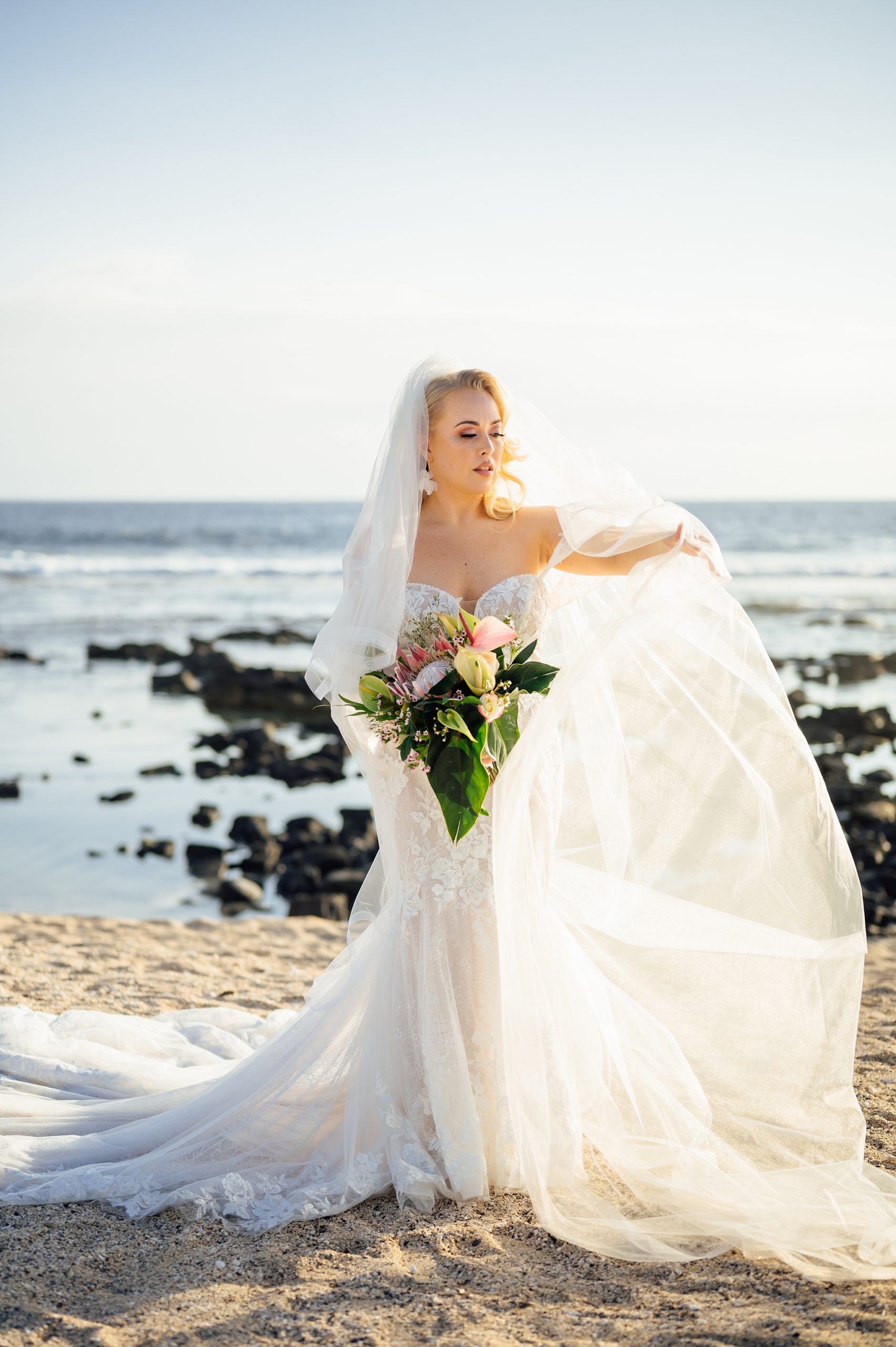 gorgeous bride with her long veil by Hawaii photographer