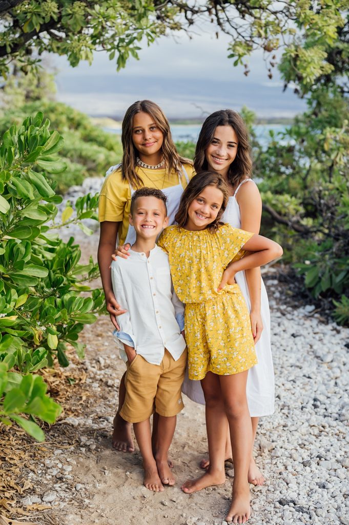 siblings with their white and yellow outfit during their vacation