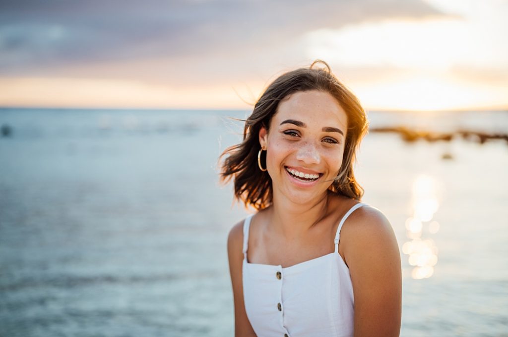 happy young lady under the stunning Hawaii sunset