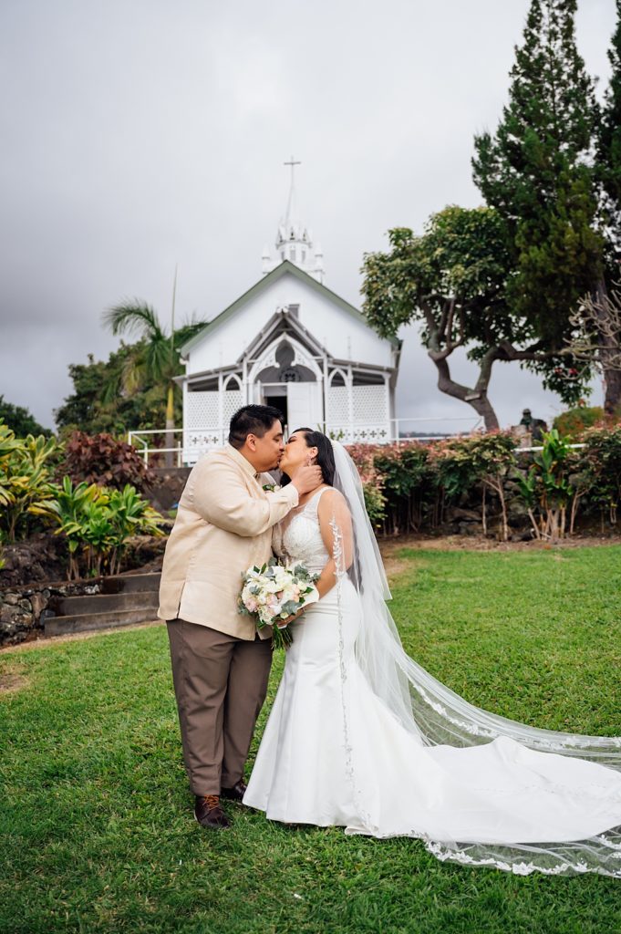 newlyweds kiss in front of the Painted Church 