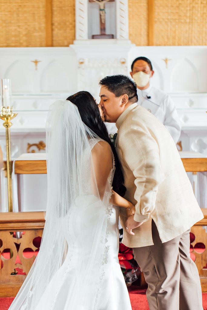 bride and groom kiss during their Hawaii wedding 