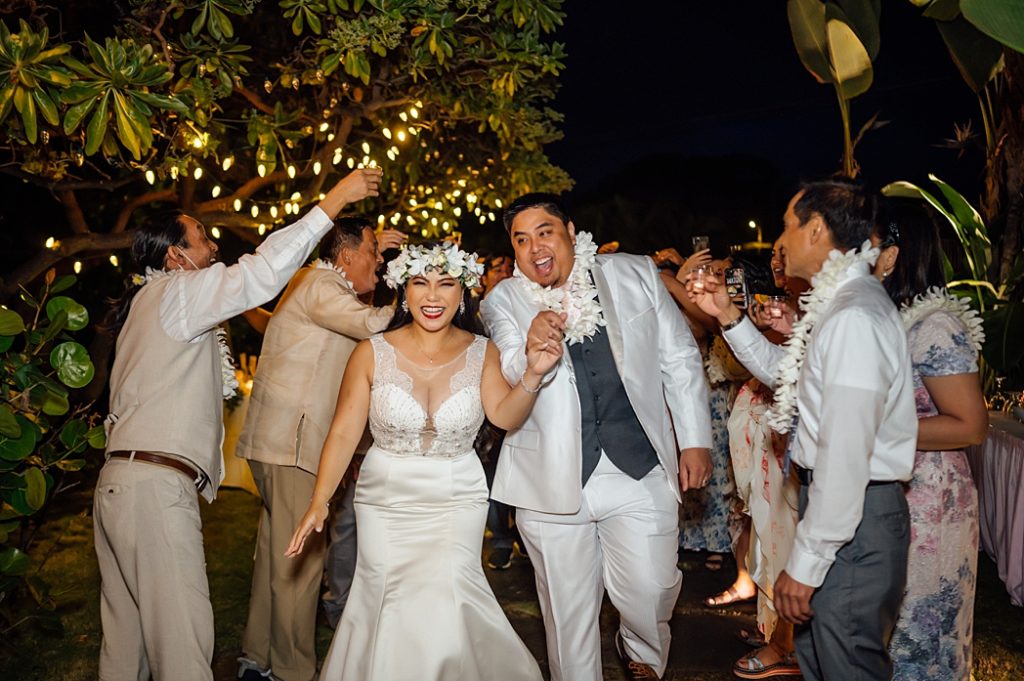 happy newlyweds holding hands during their Big Island wedding 