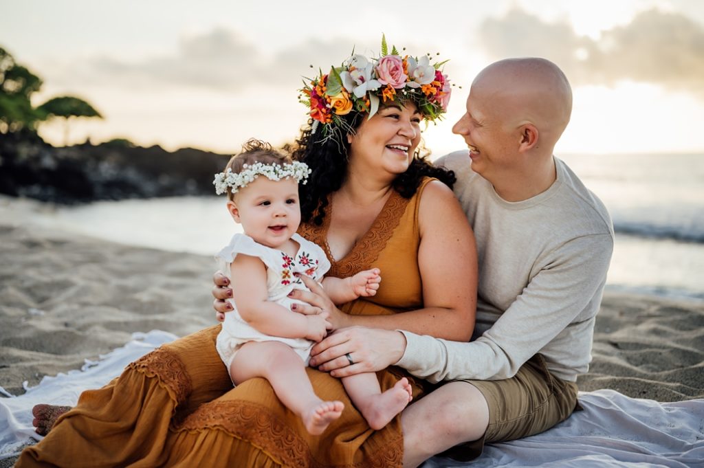 candid family photo in Hawaii at the beach during sunset
