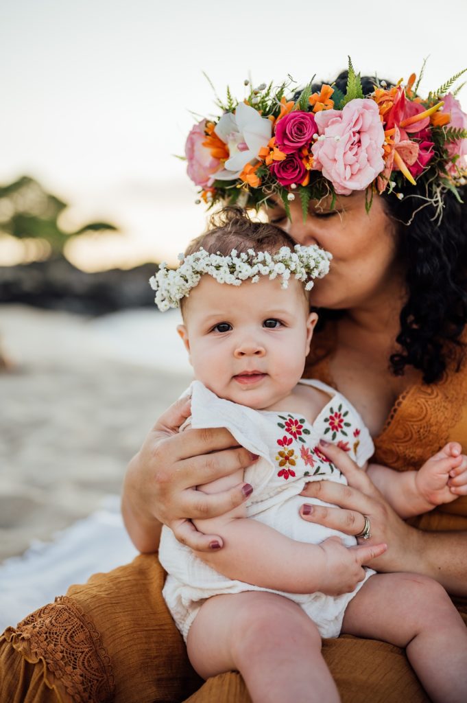 photo of adorable baby sitting on mom's lap in Hawaii