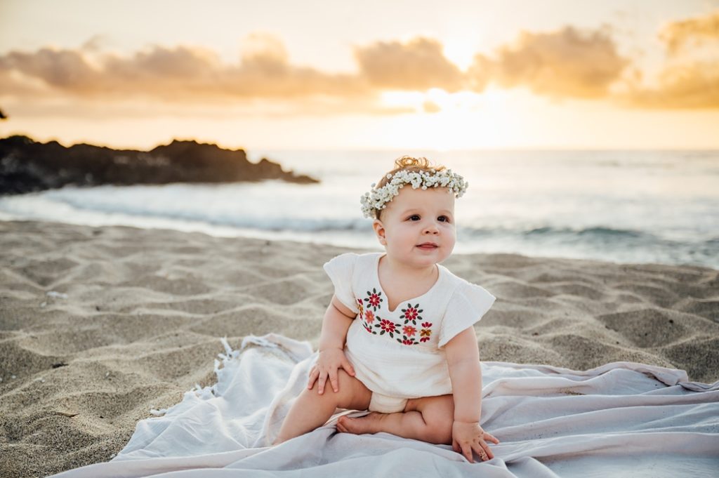 photo of a baby girl on the sand at Hawaii beach
