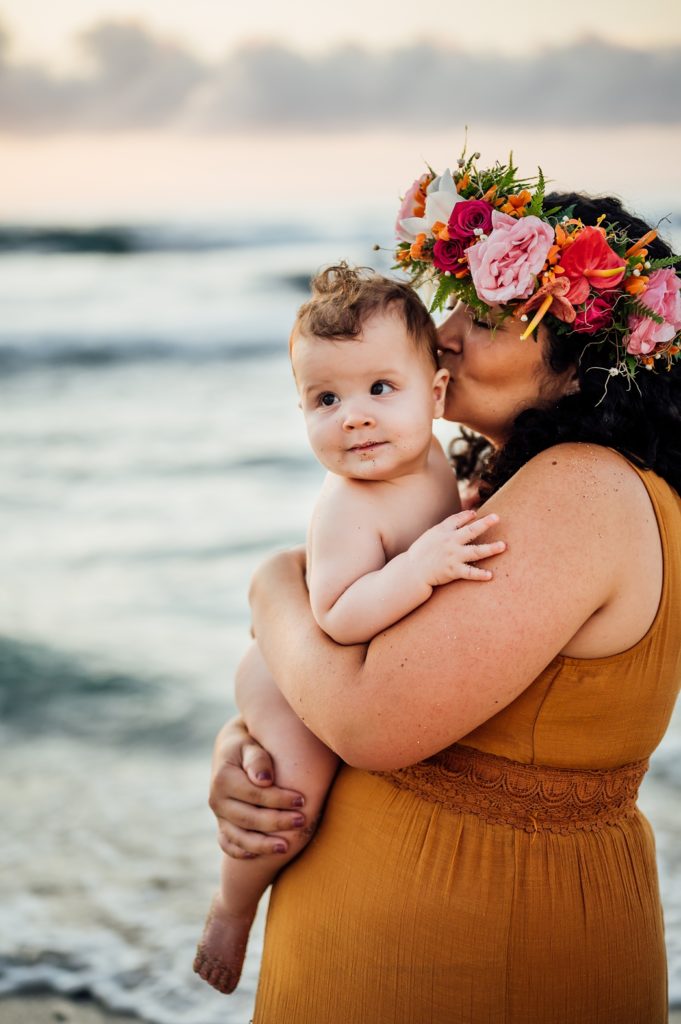 photo of mom kissing her baby at Hawaii beach