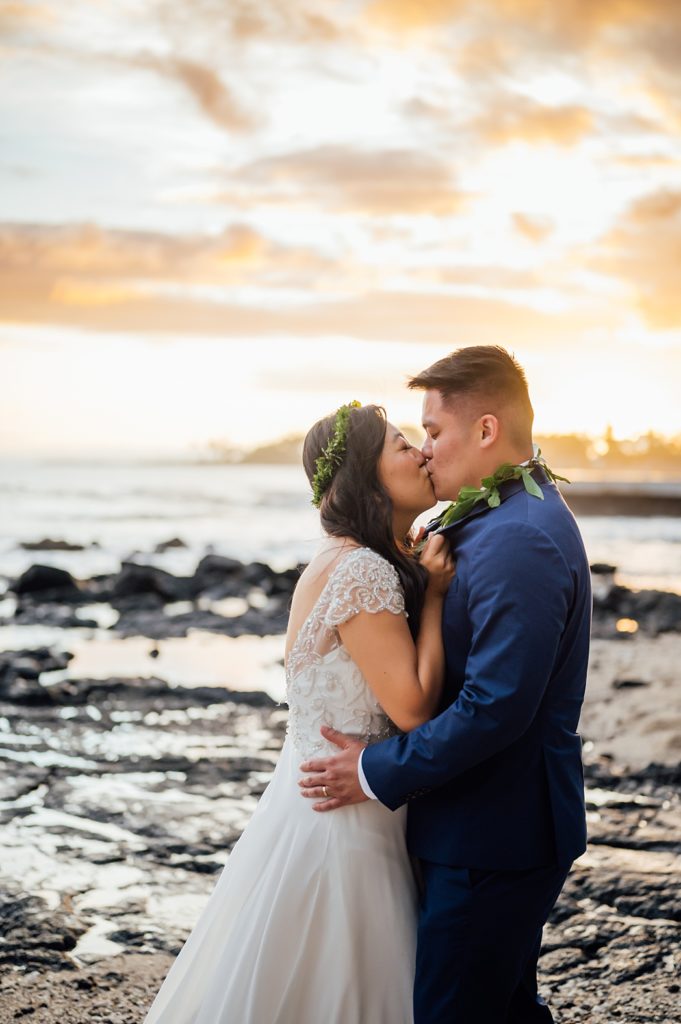 couple kissing during their beach wedding