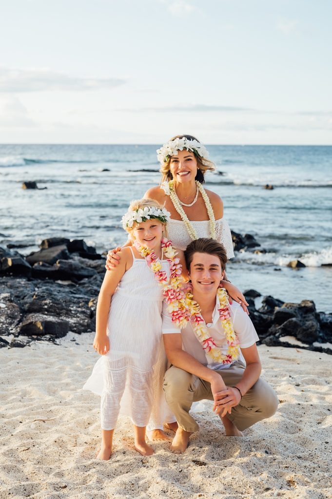 the bride with her kids at the white sand beach