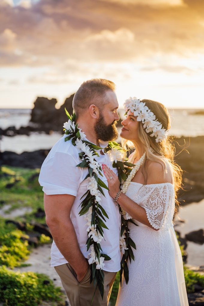 couple looking adoringly at each other under the Hawaii sunset