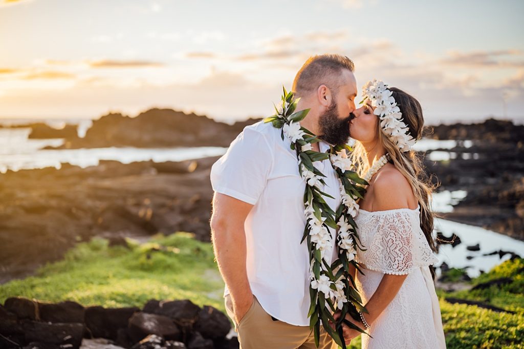 bride and groom kissing on the lava rocks