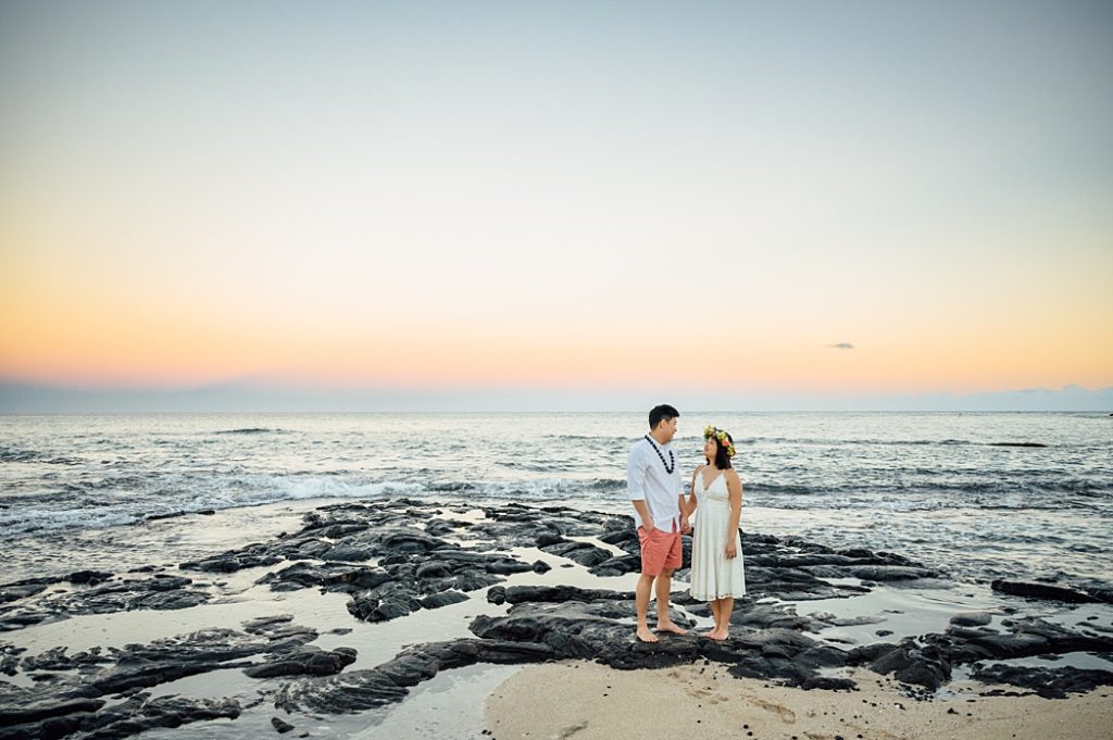 engagement photo of the couple holding hands on Hawaii beach