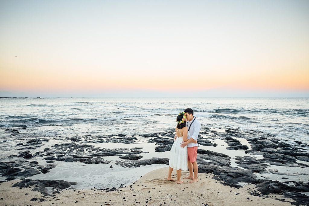 engagement photo of the couple kissing at the beach