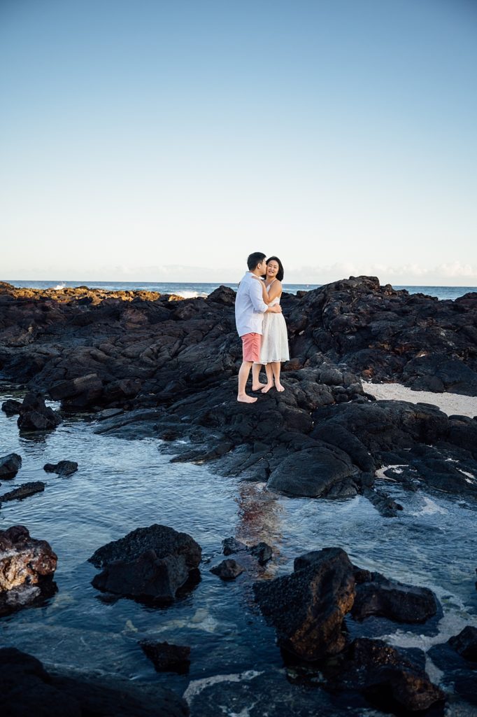 engagement photo of the couple on the lava rocks