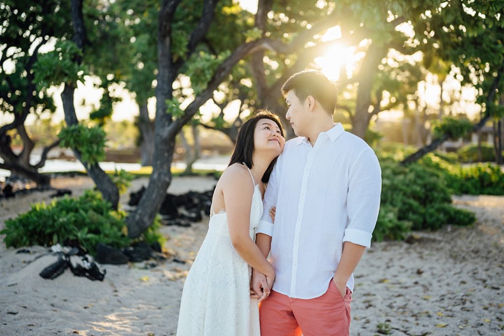 sweet photo of the couple under the Hawaii golden sunset