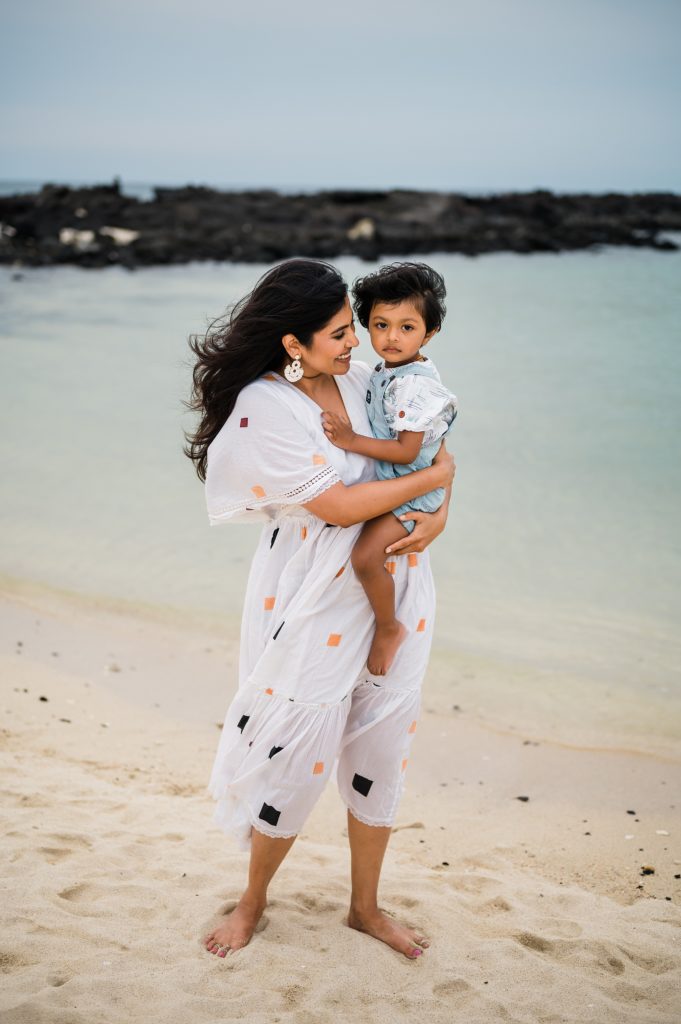 mom and son on a white sand at Hawaii beach