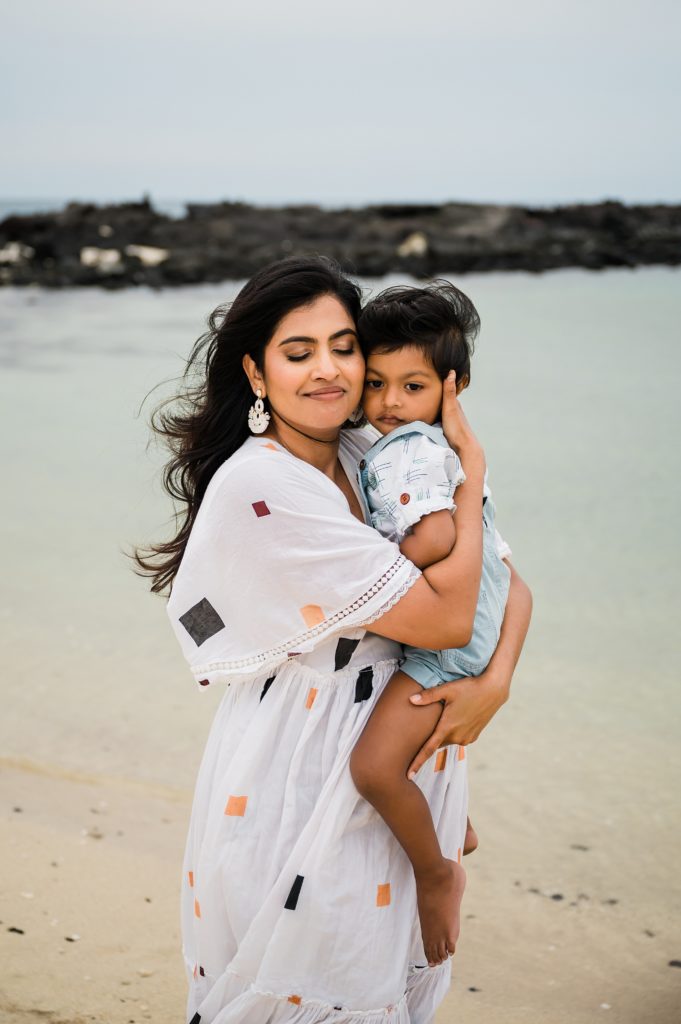 mom snuggling her son during their photoshoot in Hawaii